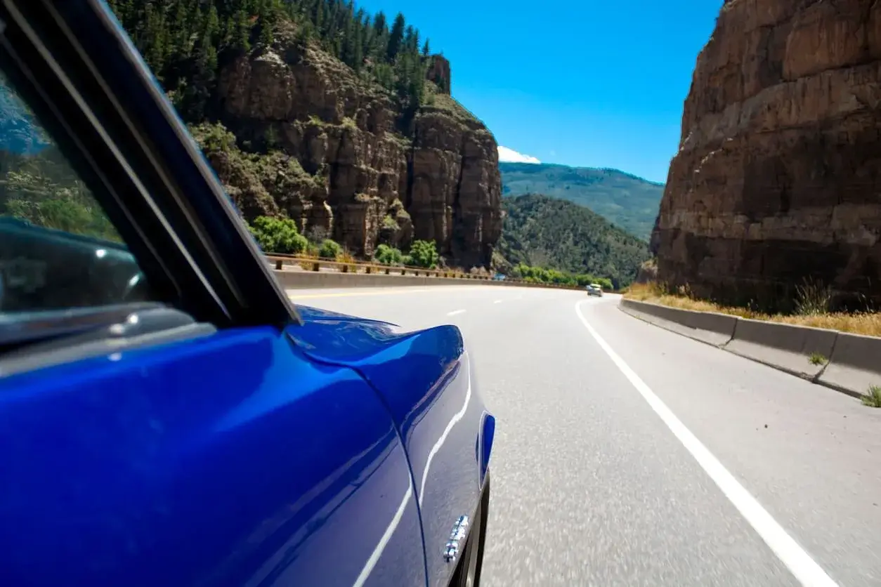 Cadillac driving through Glenwood Canyon